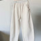 cream cotton pants on hanger