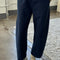 model wearing navy colored cotton canvas barrel pants with side inlets