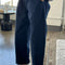 model wearing navy colored cotton canvas barrel pants with side inlets