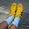 model wearing baby blue slouchy ballet socks with yellow sneakers