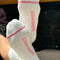 bottoms view of model wearing white slouchy ballet socks with pink trim