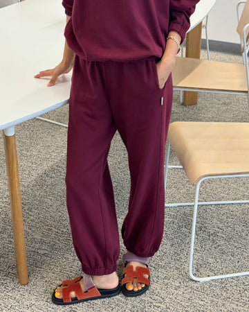 model wearing cabernet colored balloon pants