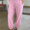 model wearing bubblegum pink cotton balloon pants with slit side pockets