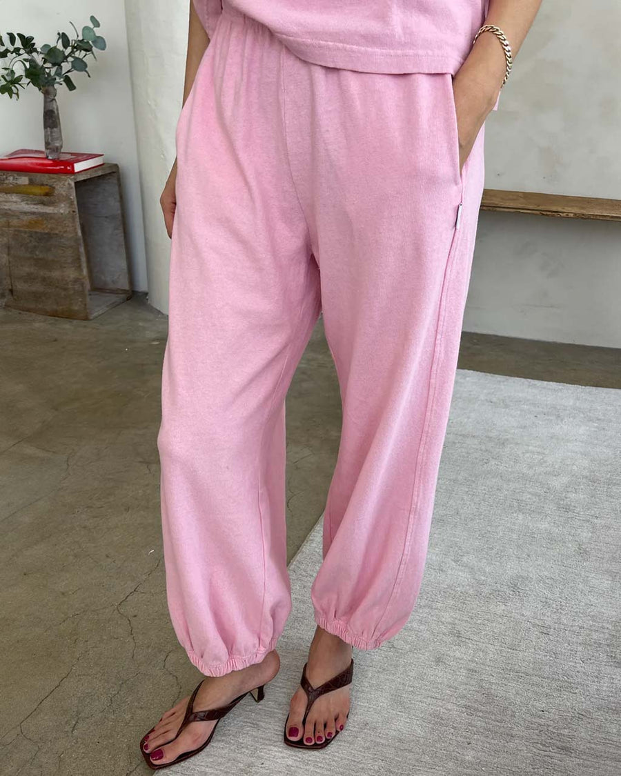 model wearing bubblegum pink cotton balloon pants with slit side pockets