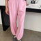 model wearing bubblegum pink cotton balloon pants with slit side pockets