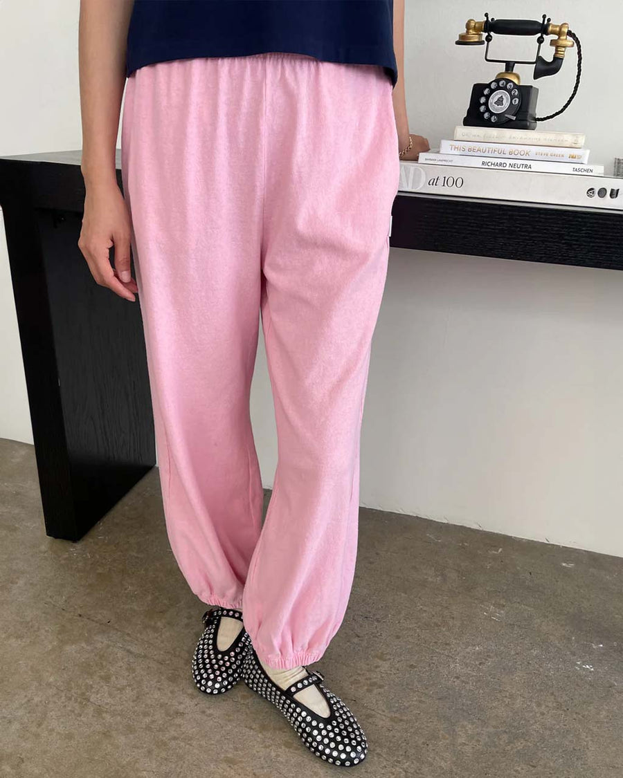 model wearing bubblegum pink cotton balloon pants with slit side pockets