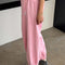 side view of model wearing bubblegum pink cotton balloon pants with slit side pockets