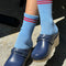 model wearing blue socks with two red stripes on the top