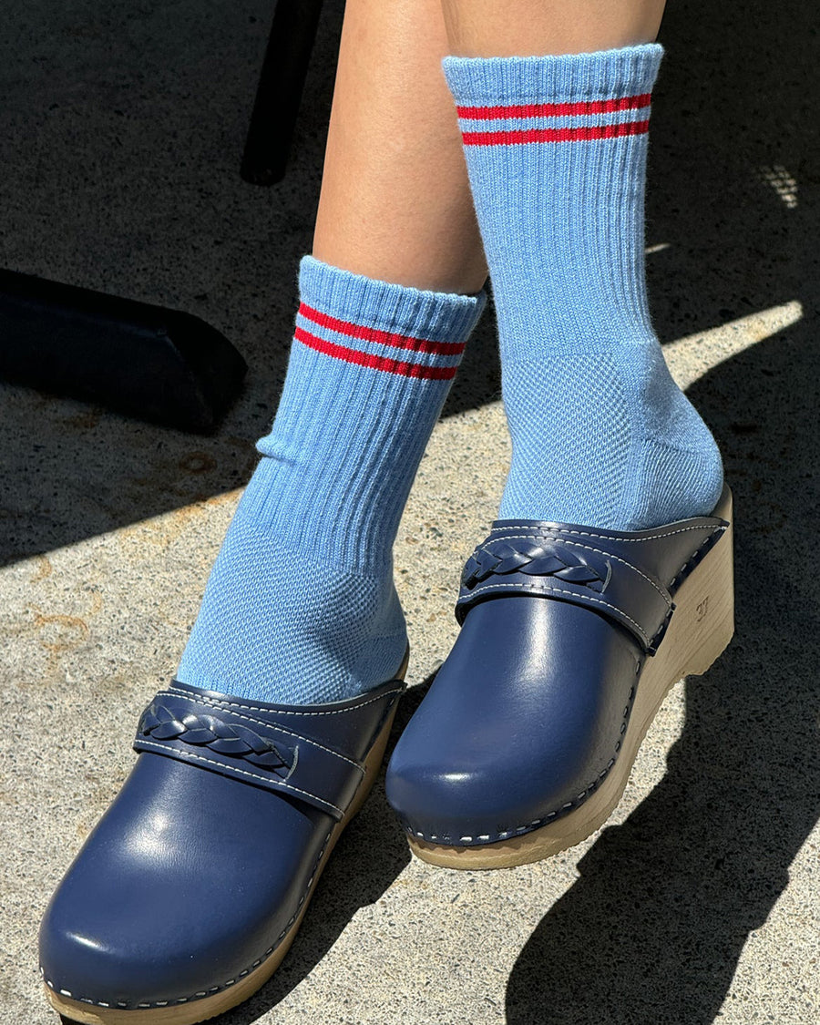 model wearing blue socks with two red stripes on the top