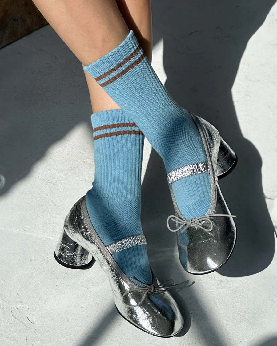 model wearing baby blue socks with brown double stripe on the top