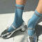 model wearing baby blue socks with brown double stripe on the top