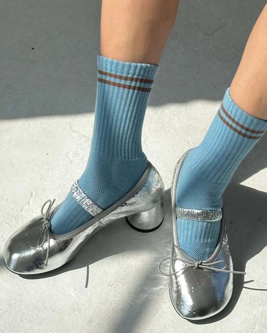 model wearing baby blue socks with brown double stripe on the top