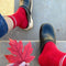 model wearing red tube socks with two white stripe detail