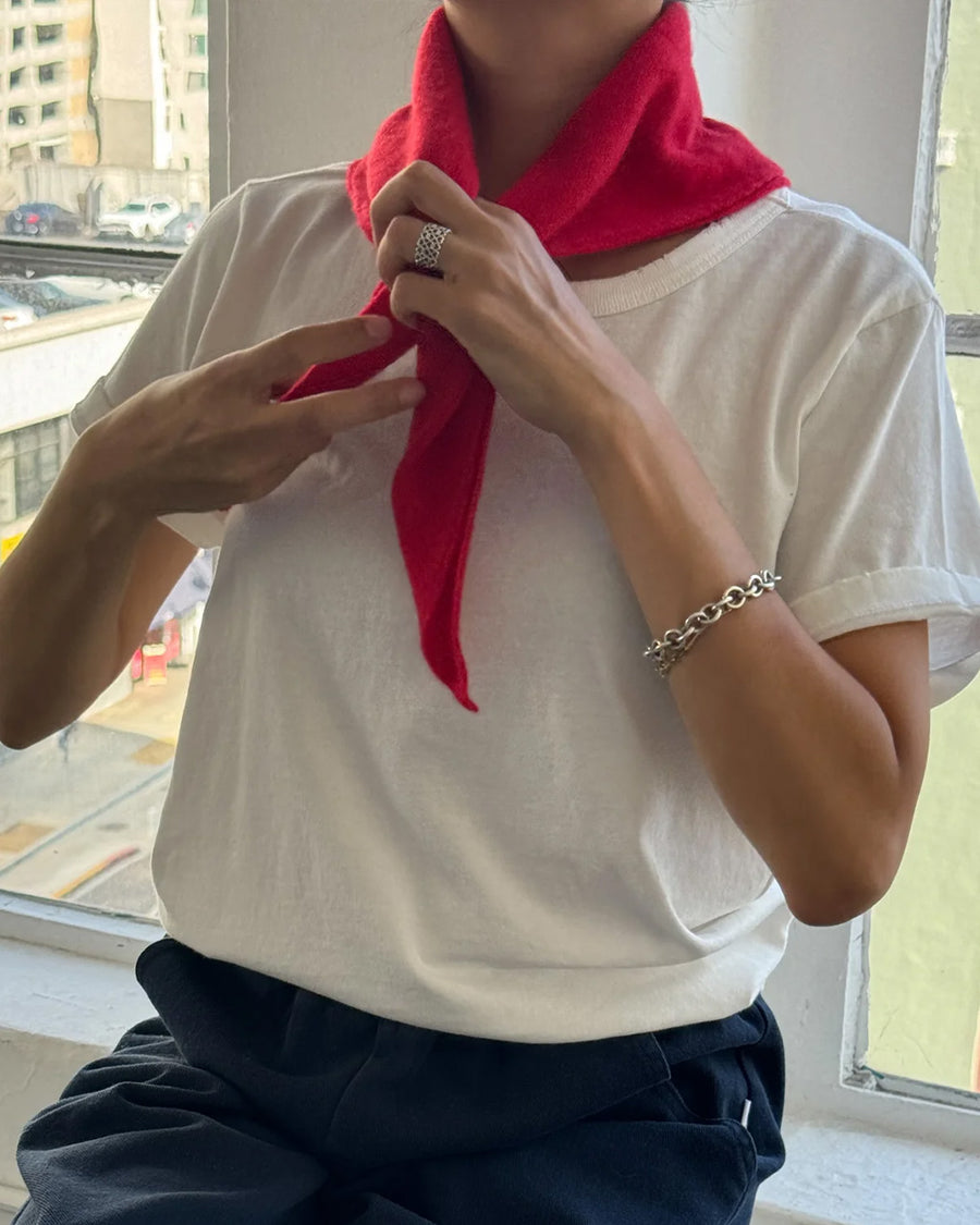 model putting red triangle cashmere scarf around their neck