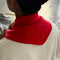 back view of model putting red triangle cashmere scarf around their neck