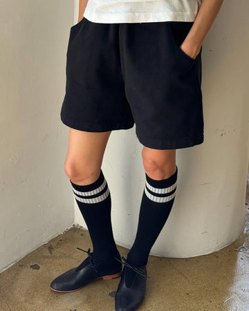 model wearing black relaxed fit shorts with pockets