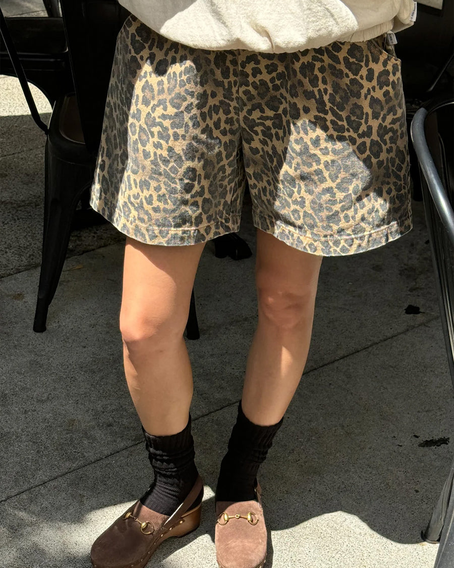 model wearing leopard print relaxed fit shorts with pockets