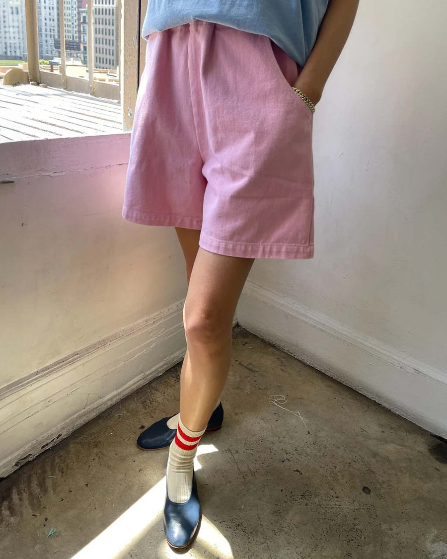 model wearing bubblegum pink cotton shorts with side pockets and elastic waistband 