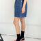 side view of model wearing denim skirt with elastic waist and pockets