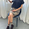 sitting model wearing brown leopard skirt with side pockets and elastic waist