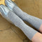 model wearing grey classic cashmere socks with silver flats on