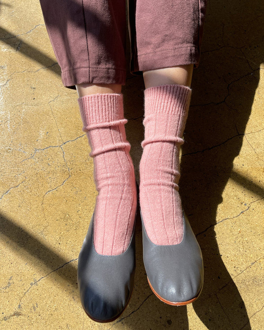 model wearing light pink classic cashmere socks with grey flats on