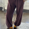 model wearing brown cotton terry balloon pants with pockets