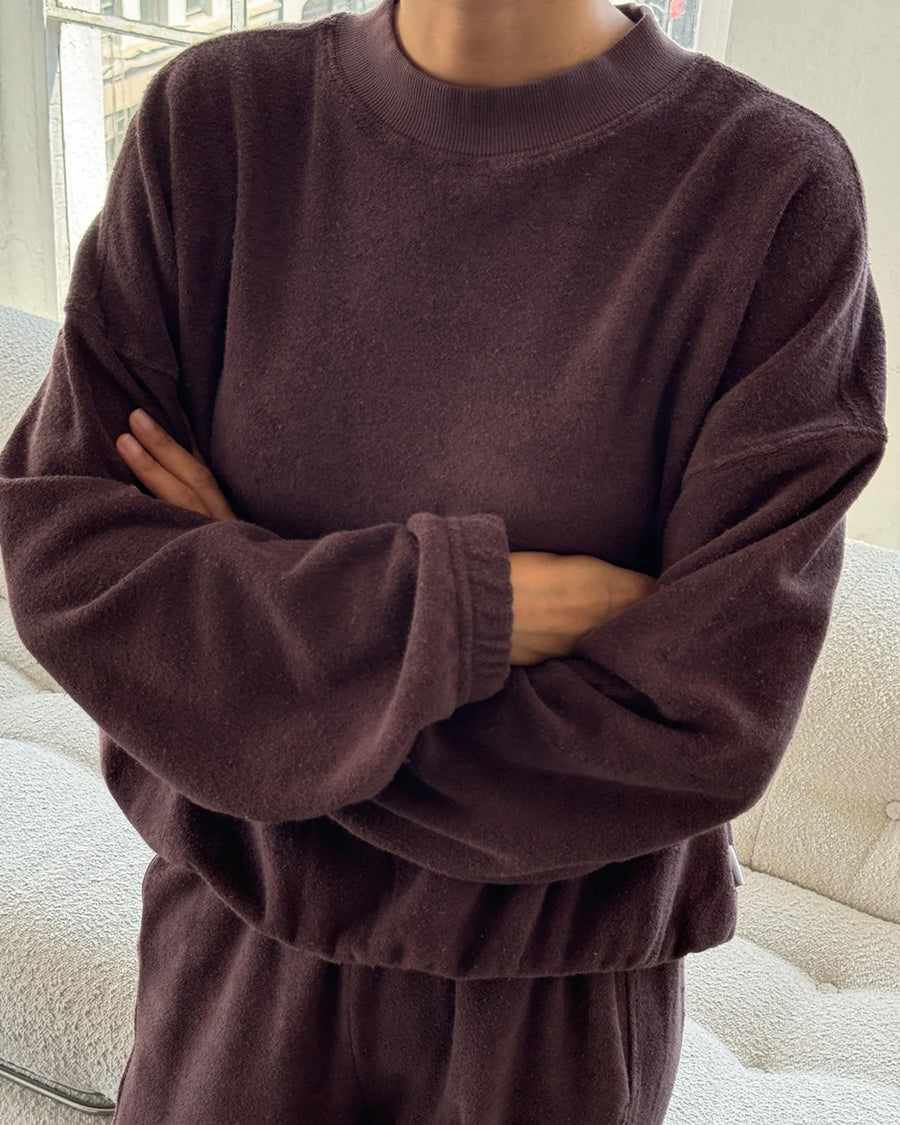 model wearing brown cotton terry long sleeve top with blouson bottom