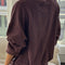 back view of model wearing brown cotton terry long sleeve top with blouson bottom