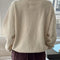 back view of model wearing brown cotton terry long sleeve top with blouson bottom