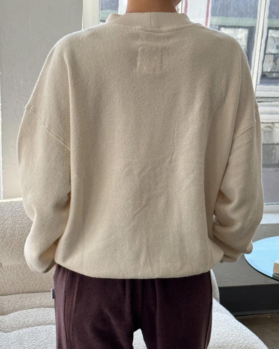 back view of model wearing brown cotton terry long sleeve top with blouson bottom