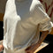 side view of model wearing naturel colored long sleeve mock neck top with elastic hem