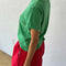 side view of model wearing emerald green relaxed tee with slight distressing on neckline and sleeves