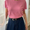 model wearing strawberry sorbet relaxed tee with slight distressing on the neckline and arm holes