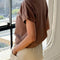 back view of model wearing chocolate cotton t-shirt with banded sleeves