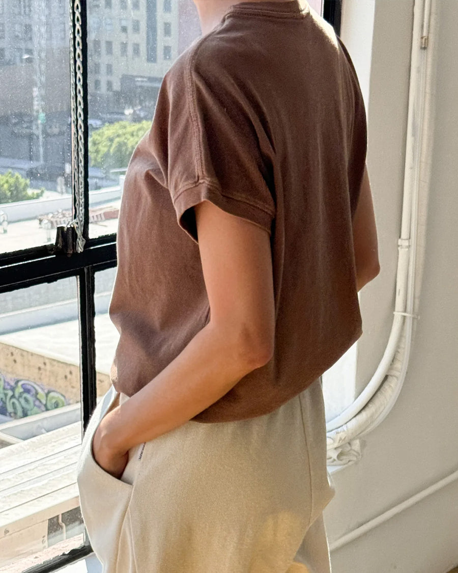 back view of model wearing chocolate cotton t-shirt with banded sleeves