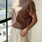 side view of model wearing chocolate cotton t-shirt with banded sleeves