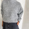 model wearing heather grey fuzzy sweater with relaxed fit and mock neck