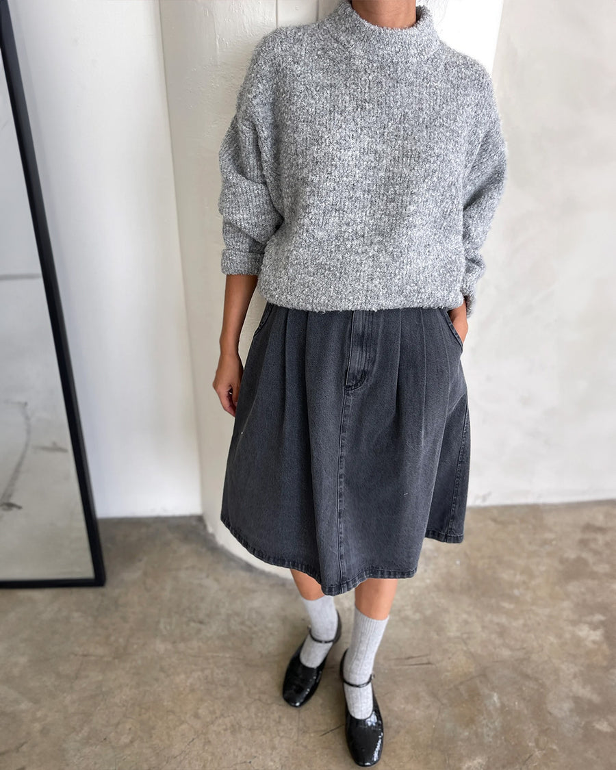 model wearing heather grey fuzzy sweater with relaxed fit and mock neck