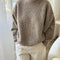 model wearing taupe fuzzy sweater with relaxed fit and mock neck