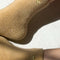 up close of model wearing fuzzy tan socks with gold metallic heart detail