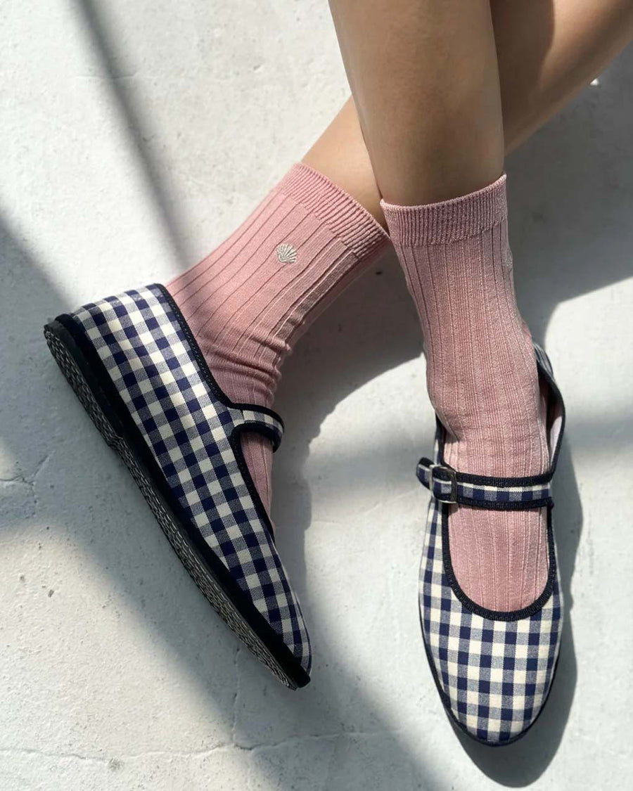 model wearing light pink ribbed socks with silver seashell detail