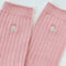 pair of light pink ribbed socks with silver seashell detail