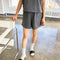 model wearing coal flared cotton basketball shorts