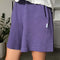 up close of model wearing eggplant purple cotton shorts with elastic waist and side pockets