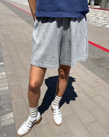 model wearing heather grey cotton socks with elastic waist and side pockets