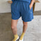 model wearing ocean blue flared cotton basketball shorts