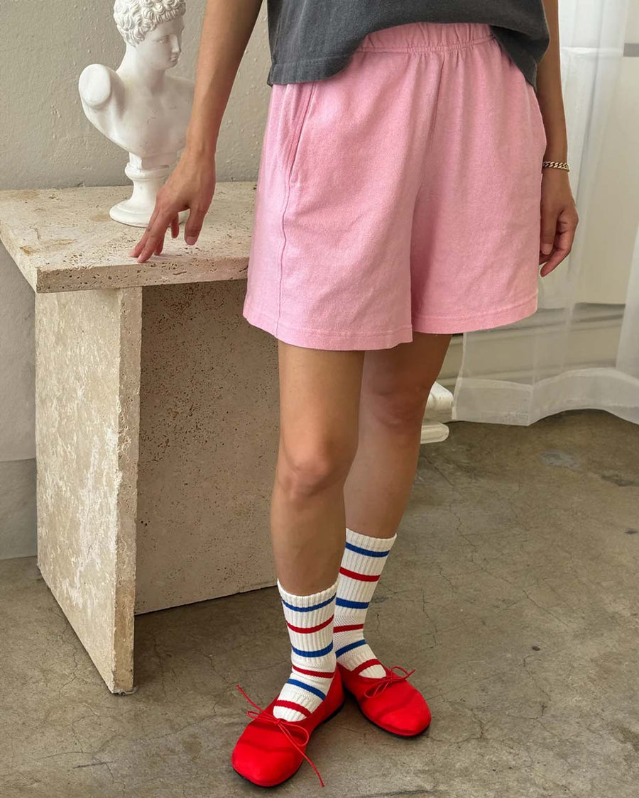 model wearing bubblegum pink flared cotton basketball shorts