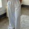 model wearing relaxed heather grey sweatpants with side pockets