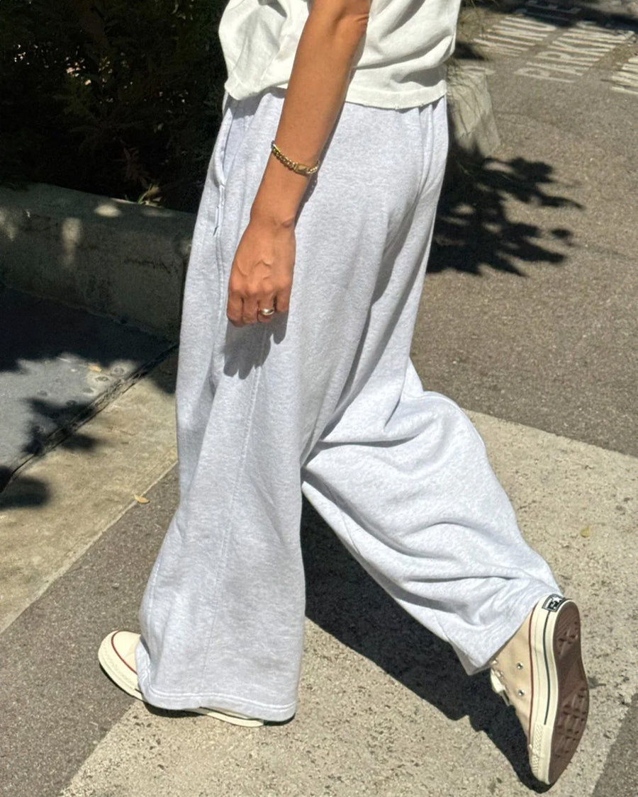 side view of model wearing relaxed heather grey sweatpants with side pockets